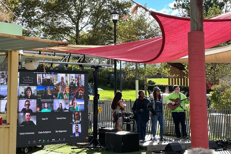 Teachers Pay Teachers band performing in a park while remote team members watch virtually