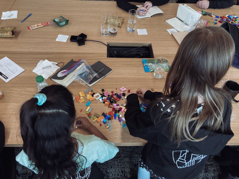 Children playing with legos on Celonis conference table.