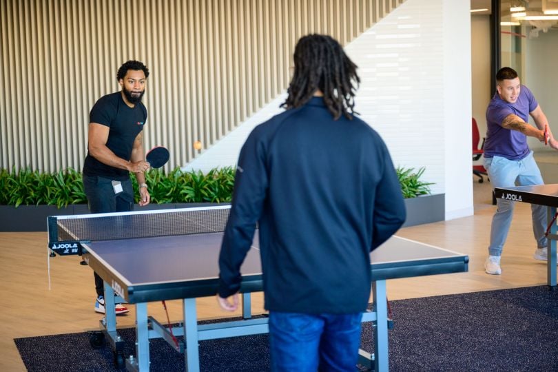 CarGurus employees playing table tennis in the company’s new global headquarters inside Boston’s new Lyrik Back Bay project at 1001 Boylston Street. 