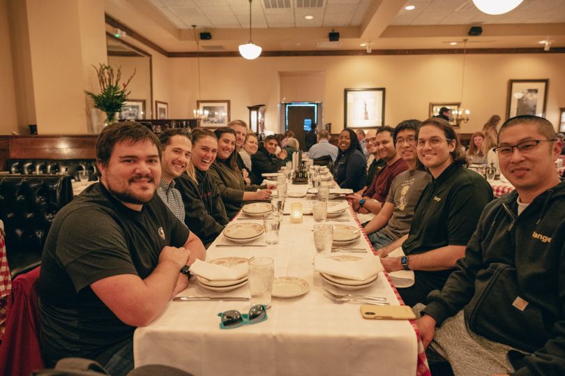 Long dinner table flanked by Range employees, Chowdry Ahmed at the far end