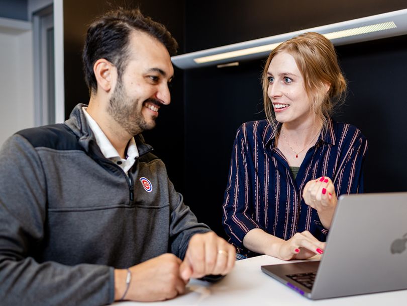 Andres Colon and a Productive Edge colleague looking at a work laptop