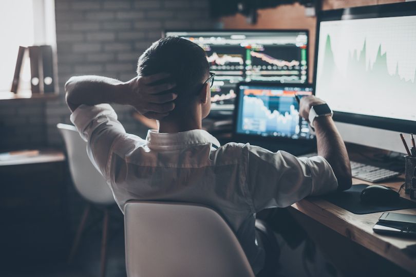 The Options Clearing Corporation employees looking at computer monitors