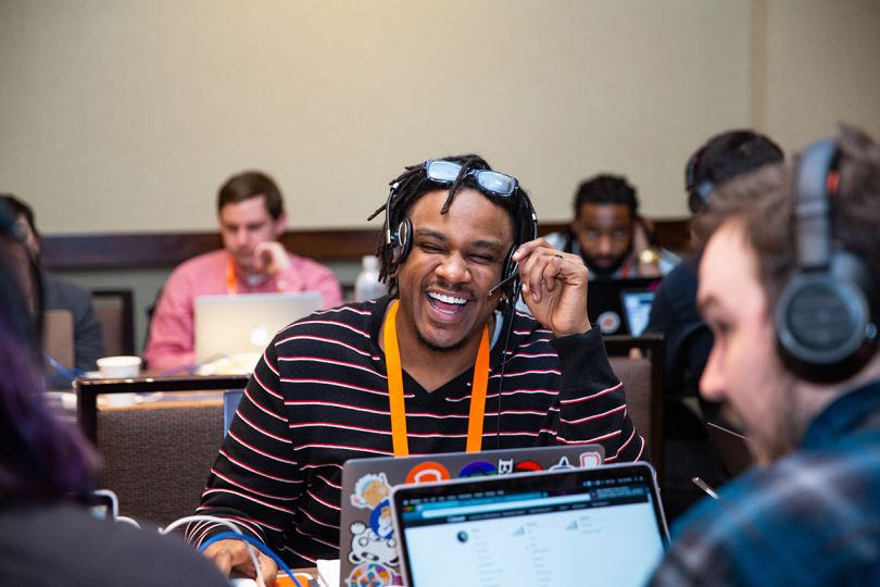 Toast team members in the office with headsets working on laptops