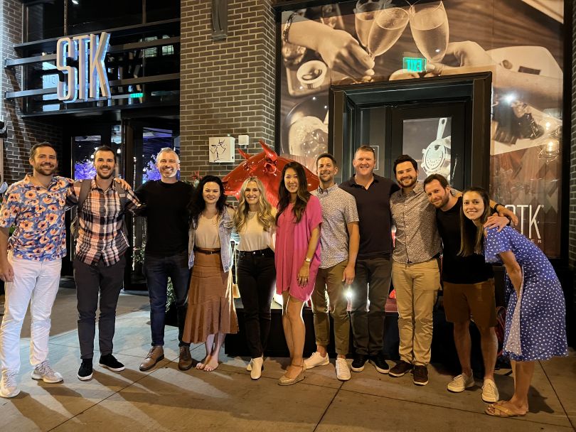 Udemy team members standing together outside of a restaurant