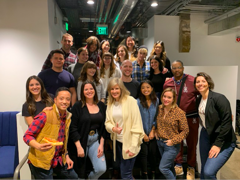 A group of Unity employees together in the office.