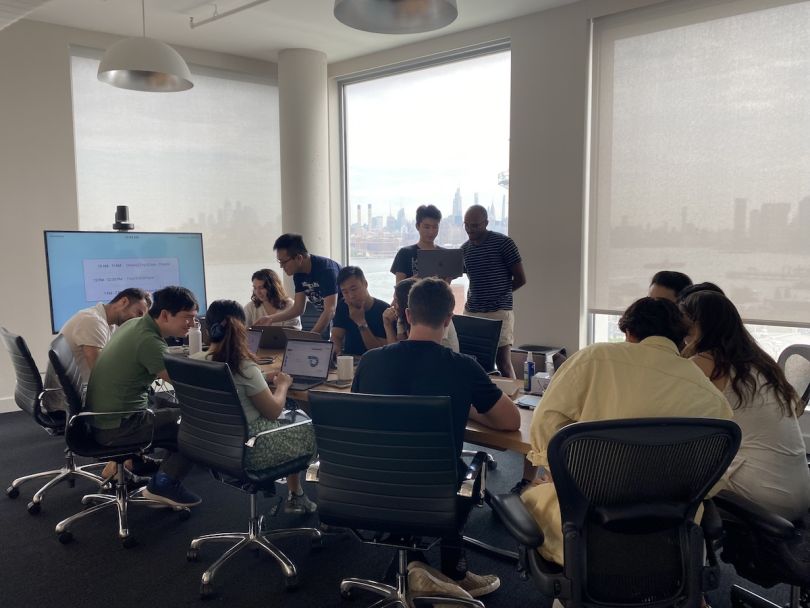 The Up&Up team gathers in a conference room