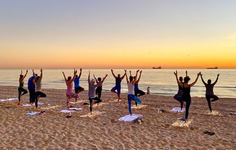 Viz.ai team members doing yoga on the beach