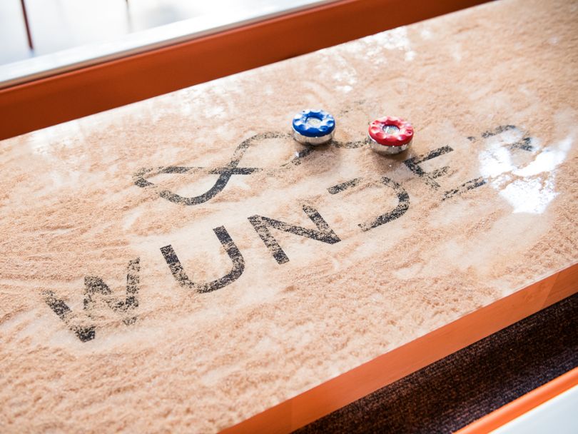 Wunder logo on a shuffleboard table