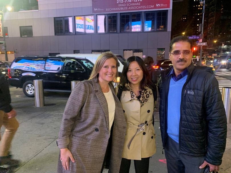 Photo of Hater and Lu standing together with a colleague outside. 