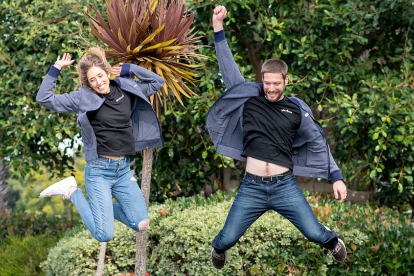 Two Yembo team members jumping in the air