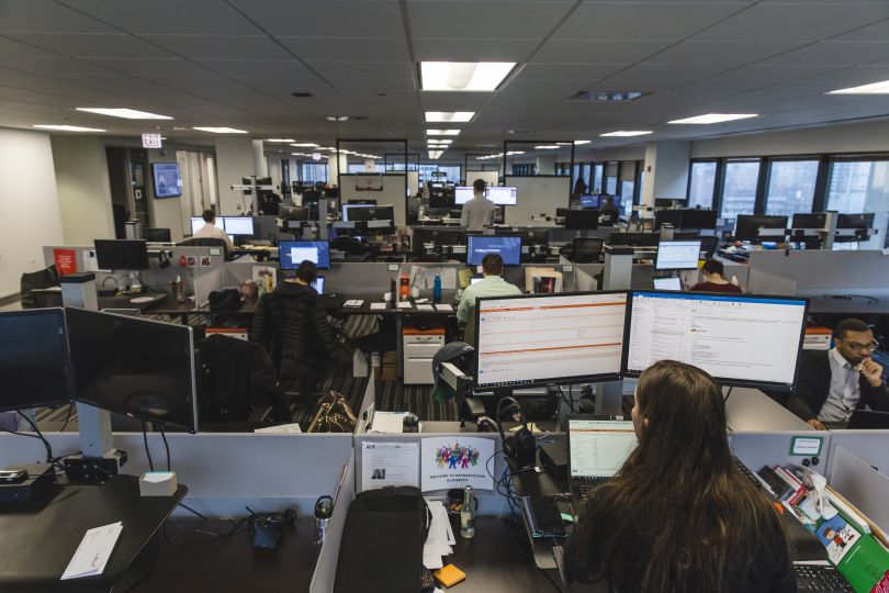 Photo of Litera’s office, with workers at desks with computer screens.