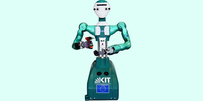 The humanoid robot, Armar 6, holding a drill.
