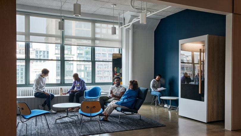 Harry’s team members sitting in a common area of their office.