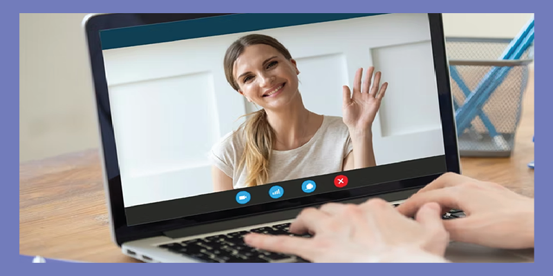 A person on a video call on their laptop with their Calibrate health app coach.