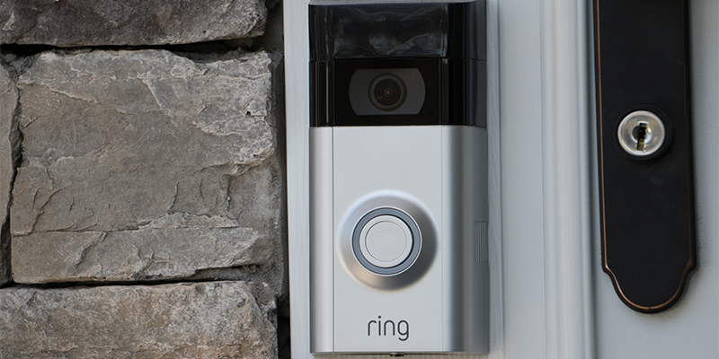 A Ring camera doorbell attached to a home's front entrance.