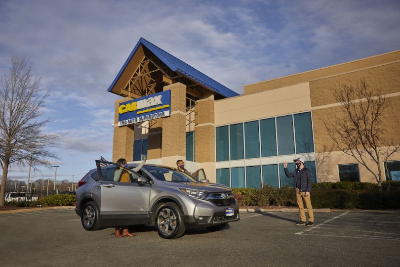 CarMax location with customers getting into a car