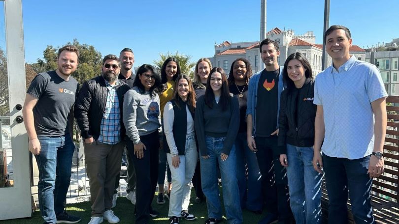 A group photo of GitLab employees outside. 