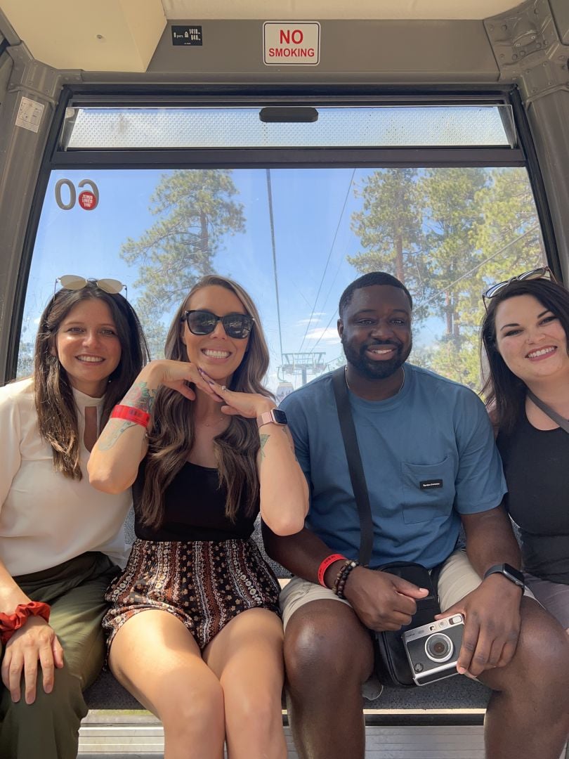 Customer.io team members smile at an event. 