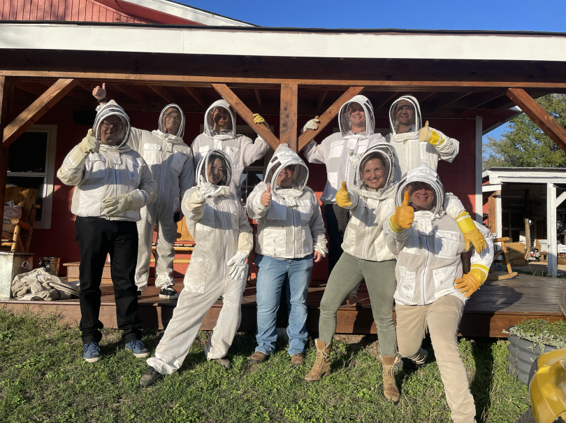 Customer.io team members wearing bee keeper gear.