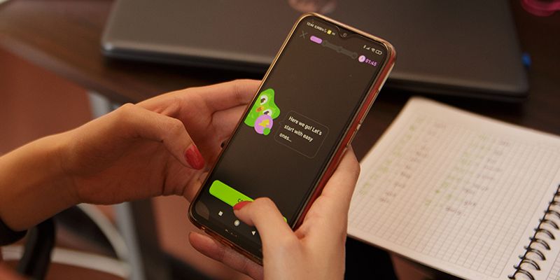 A person using the Duolingo AI App.