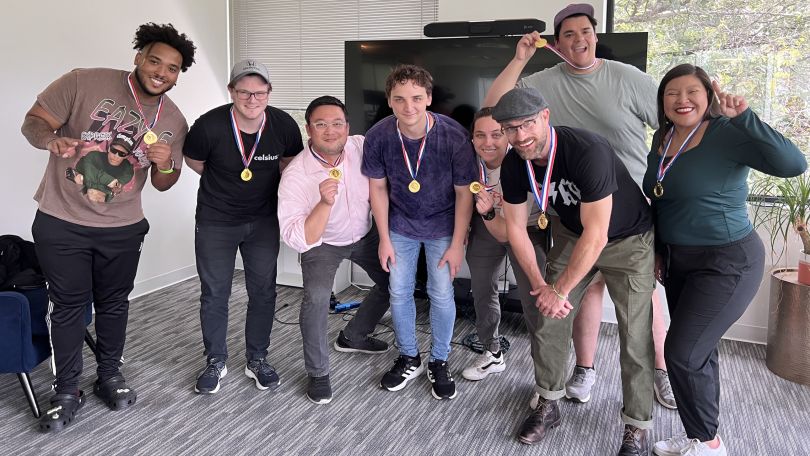 ePayPolicy team members pose for a group photo with gold medals around their necks.