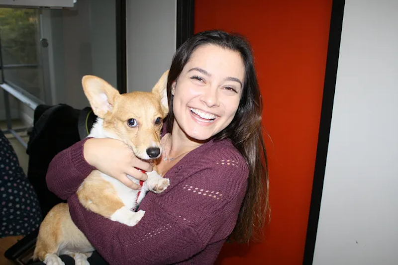 Golden Hippo staff member holding a dog