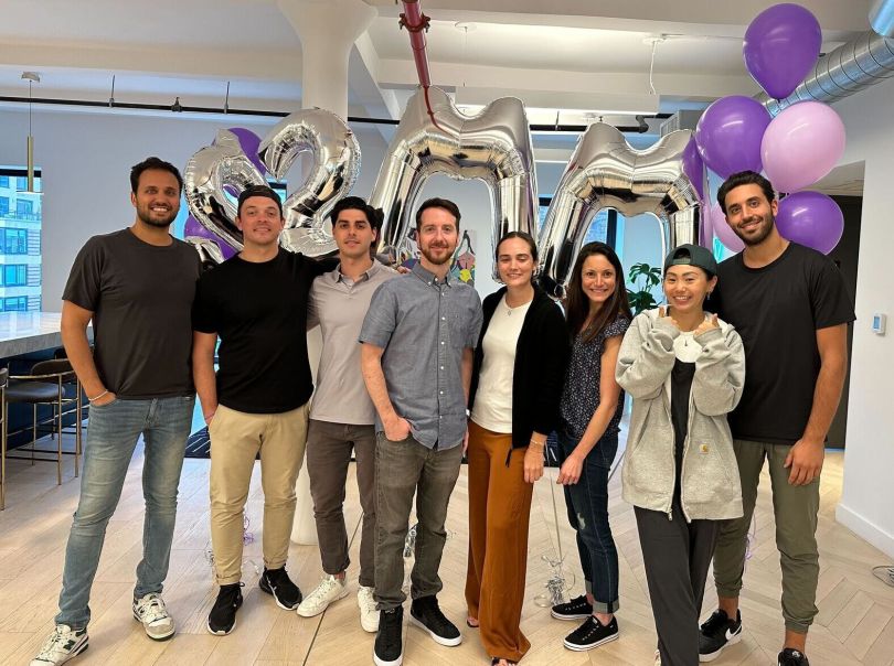 Gynger team group photo in front of balloons