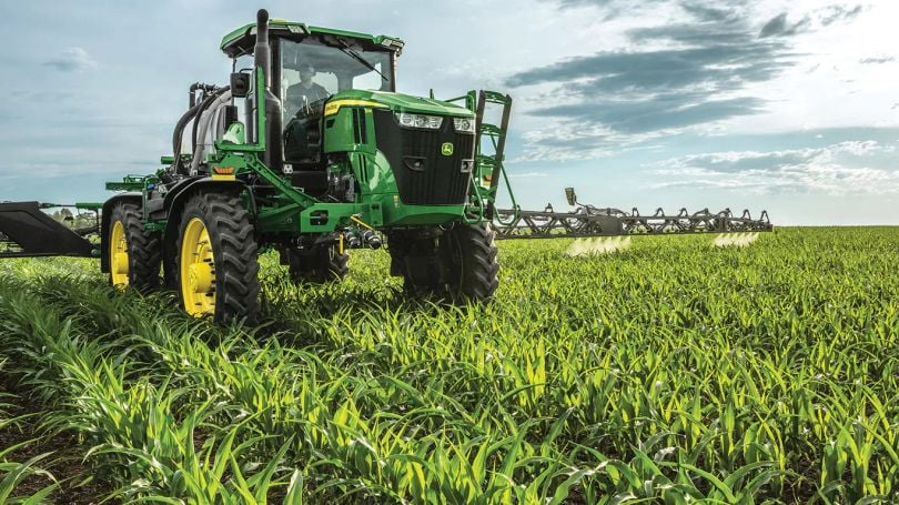 Farmer driving John Deeresprayer with See & Spray technology.