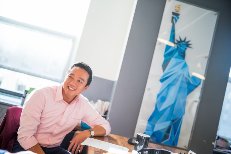 Liberty Mutual employee in front of statue of liberty art