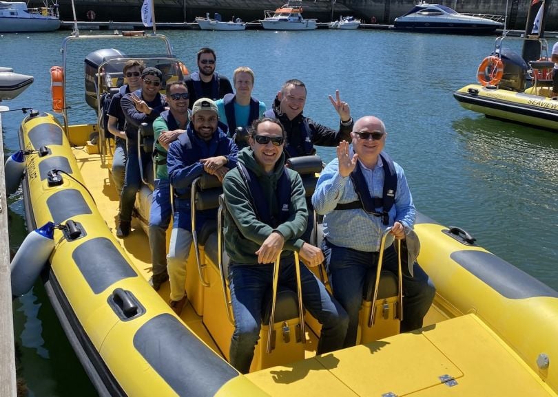  Liftoff team members enjoy a boat ride on a company outing. 