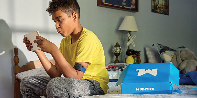 A child playing games on the Mightier health app while wearing the Mightier heart rate monitor.