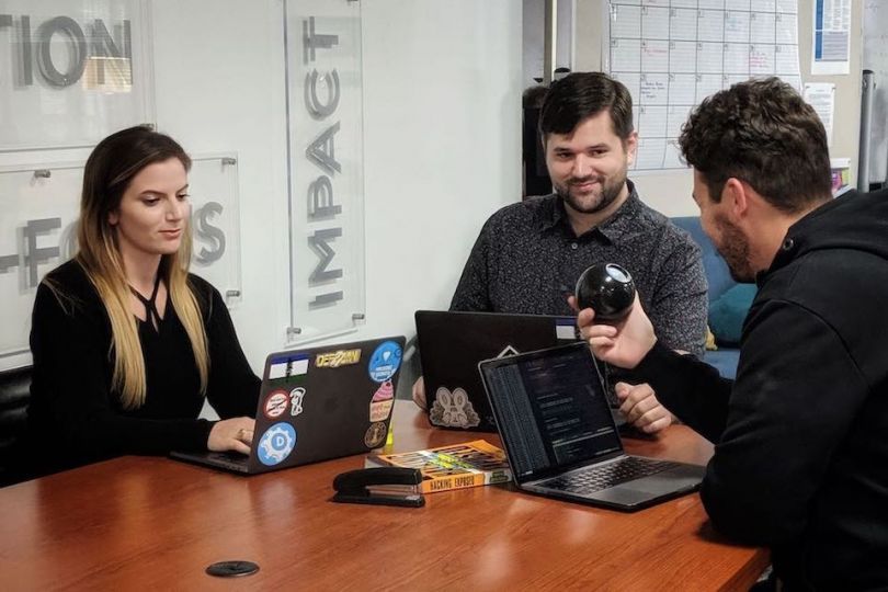 DomainTools team members working at a table