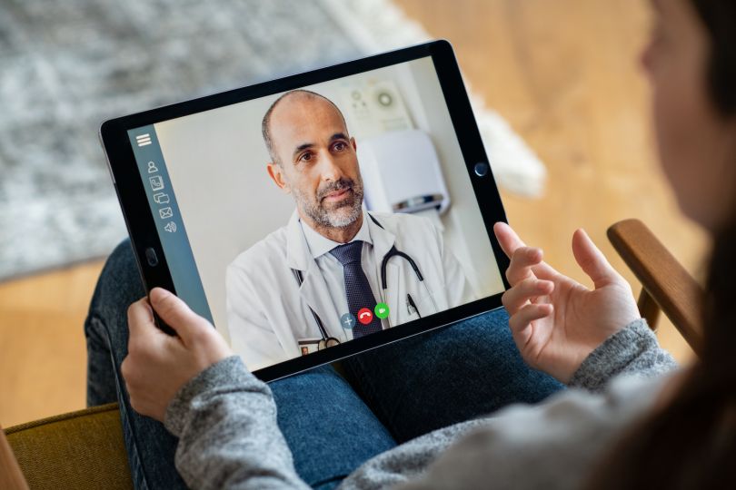 A doctor speaks to a patient using telehealth