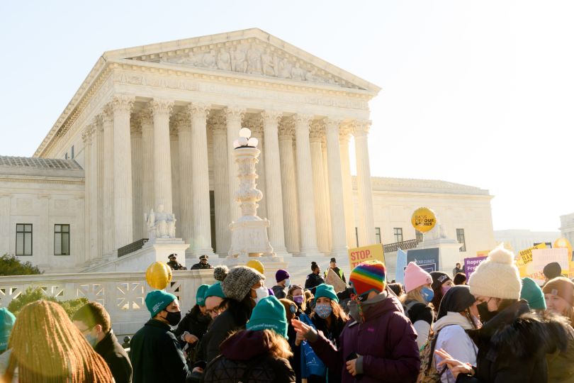 The Supreme Court Building with protestors outside after the Dobbs v. Jackson ruling