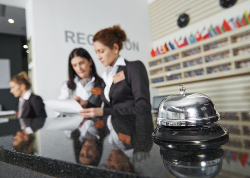 myDigitalOffice acquires Focal Revenue: Image description: Hotel workers stand at a reception desk.