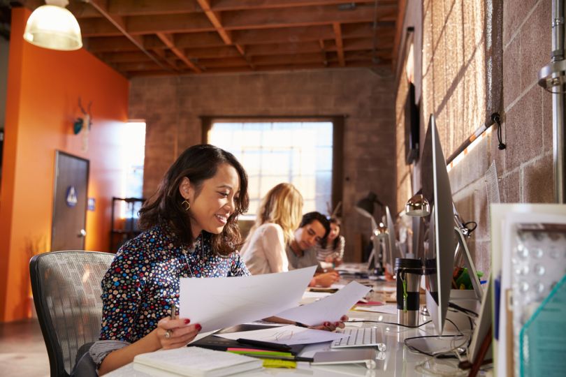 Employees working at desks in an office environment.