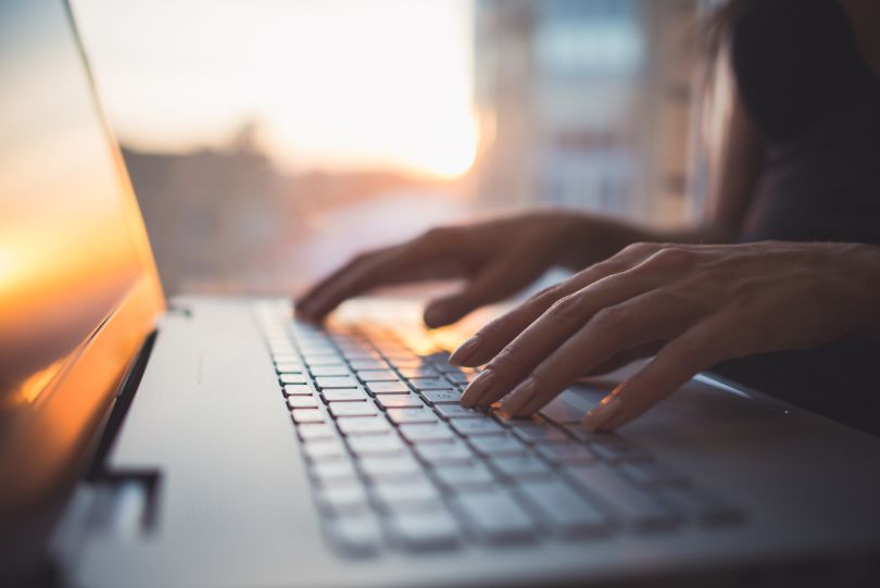 An image of a woman on a computer. 