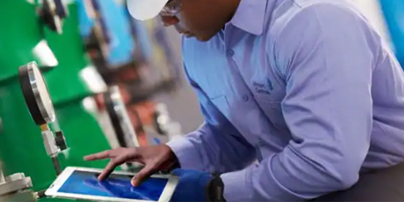 A person interacting with Smart Chiller IoT equipment through a tablet.