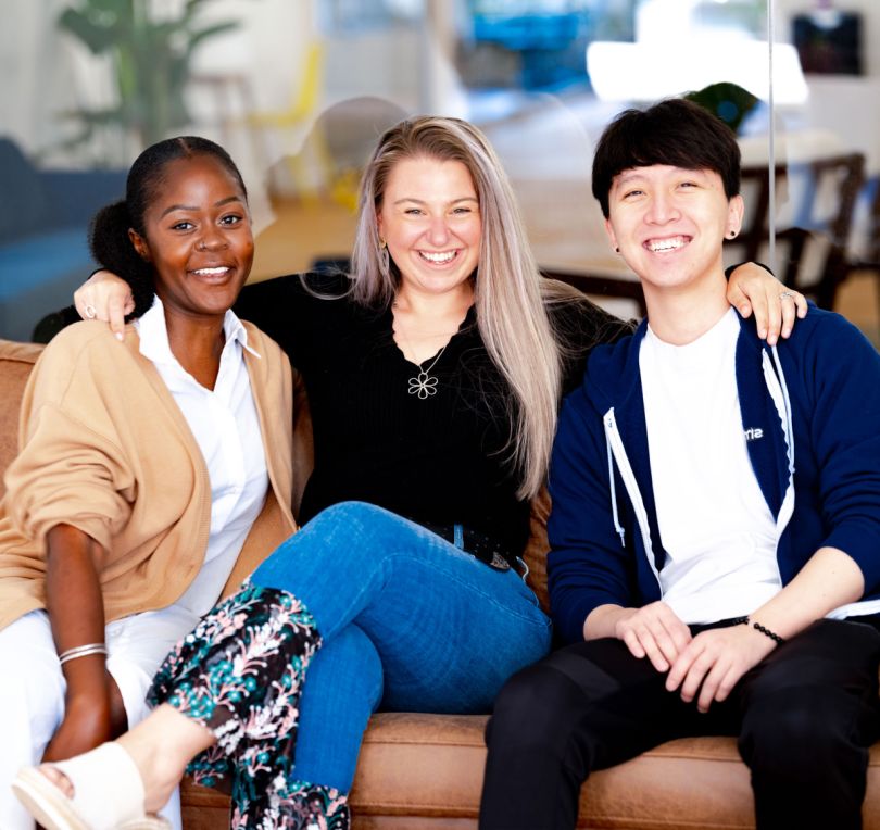 Three Smartrr employees sit on a couch