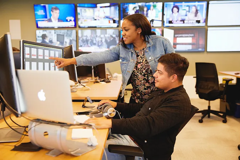 Snap employees going over information on a computer monitor