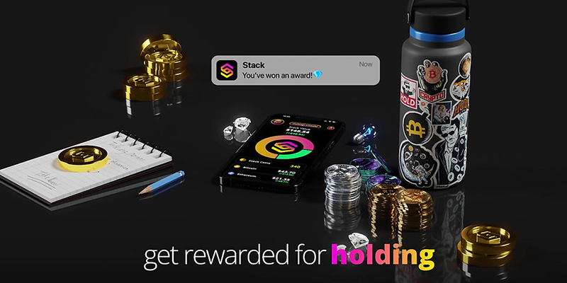 Various Stack branded product, gold coins and a mobile device displaying the Stack logo with a large message saying "get rewarded for holding."