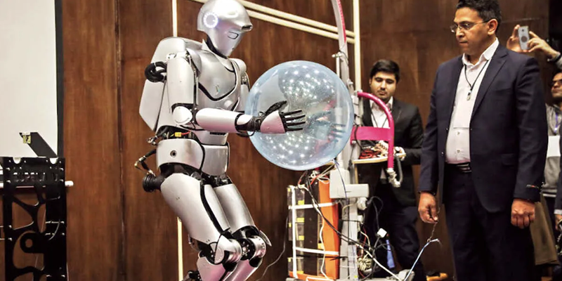 The humanoid robot, Surenal IV, holding a ballon with both hands.