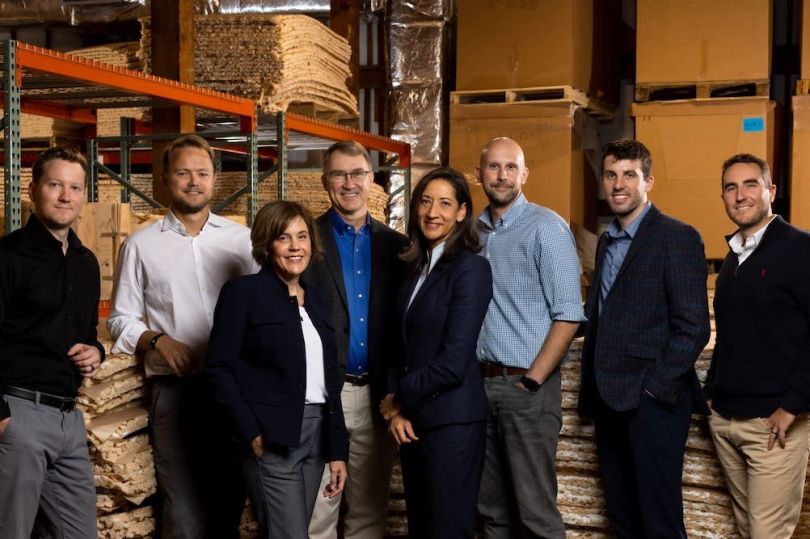 TemperPack's team poses in one of the company's warehouses.