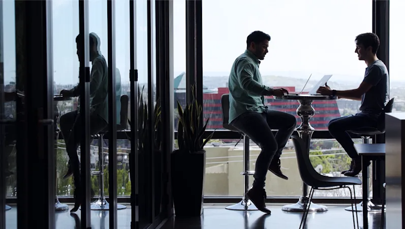 Tinder office space with staff members having a meeting