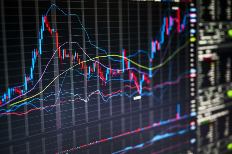 A stock market graph on a monitor showing financial data trends.