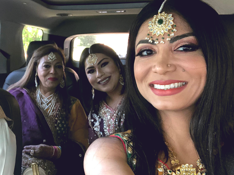 Bazgha Qutab and family members pose for a photo in formal wear.