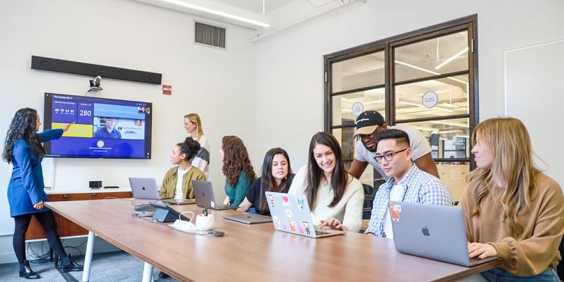 monday.com team members having a meeting in a conference room in the office