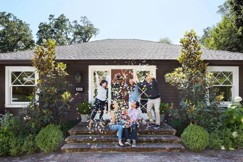 Homebuyers celebrating in front of home