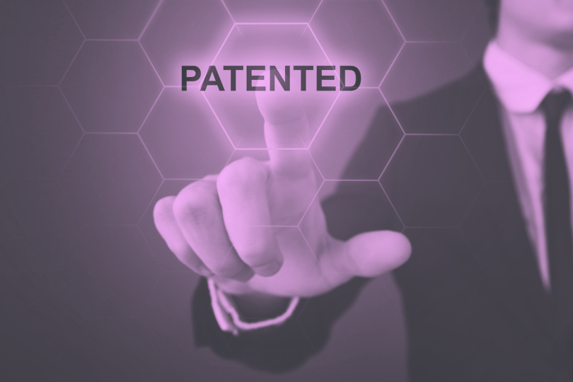 Person pressing the word "patented."
