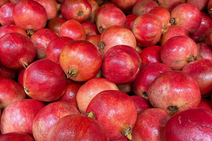 A bin full of pomegranates